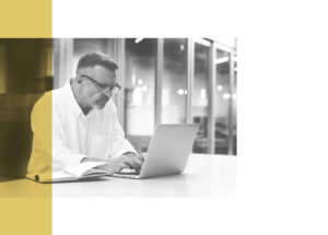 Man watching Western Europe Economic Outlook webinar on a laptop